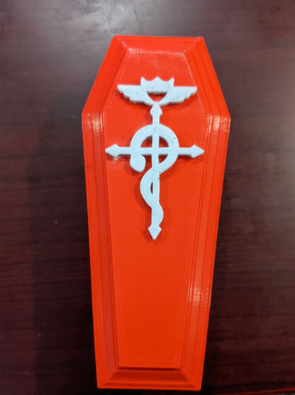 Red coffin shaped dice/trinket box with white alchemy symbol 