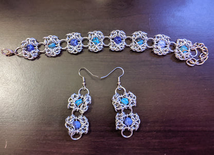 Romanov chainmail bracelet and earrings with dyed malachite beads on a desk 